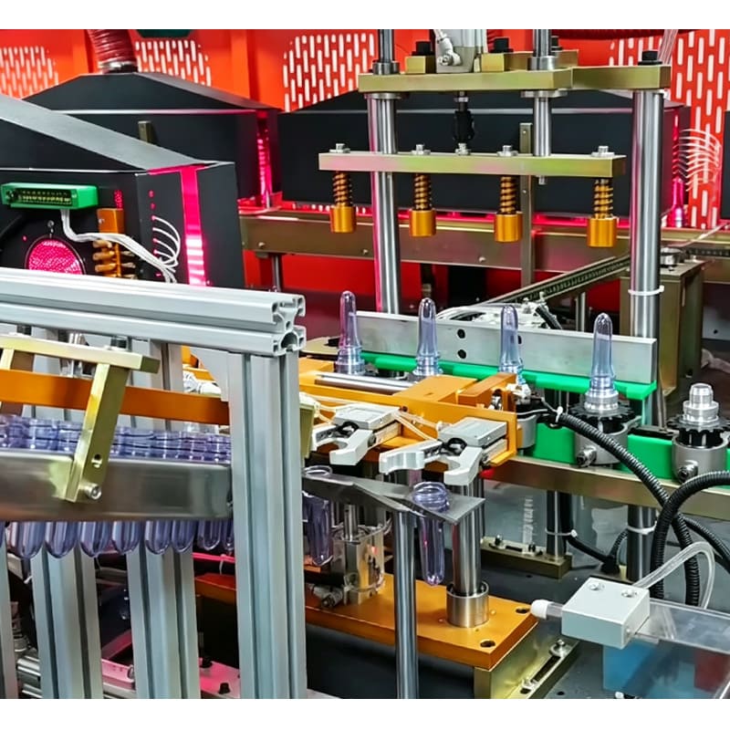 Close-up of Aomiwater 4 cavity full auto bottle blowing machine preform feeding mechanism